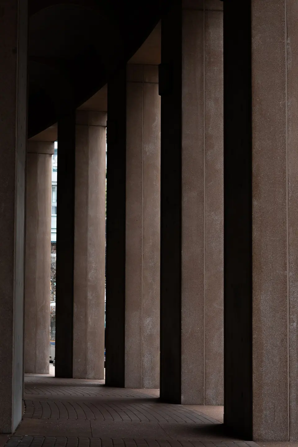 Row of tall concrete columns in a quiet architectural interior